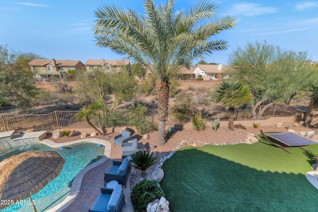 view of pool featuring a lawn