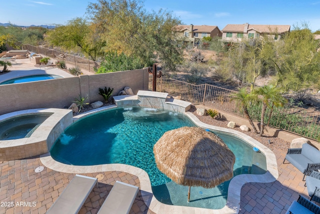 view of swimming pool with an in ground hot tub and pool water feature