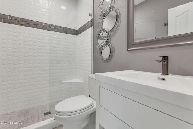 bathroom with vanity, an enclosed shower, and toilet