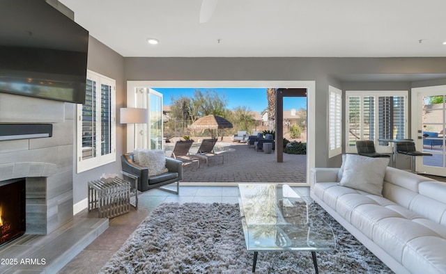 living room featuring light tile patterned floors and exterior fireplace