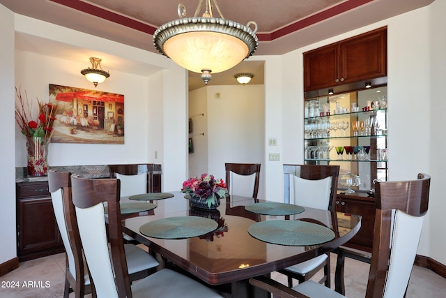 dining area with bar and light tile patterned floors