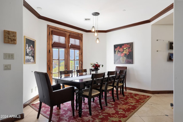 tiled dining area featuring ornamental molding and french doors