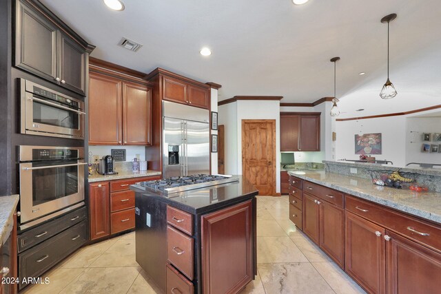 kitchen featuring hanging light fixtures, crown molding, appliances with stainless steel finishes, light stone counters, and a kitchen island