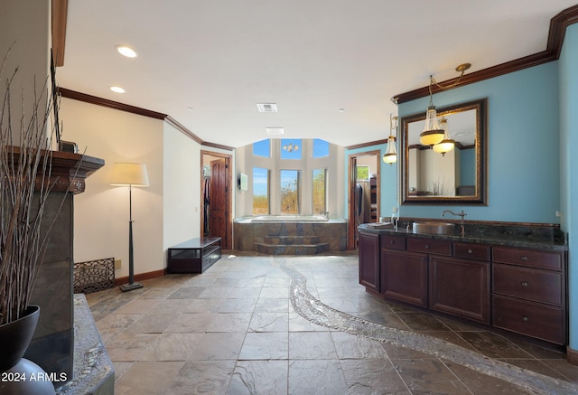 bathroom with crown molding, vanity, and a bath