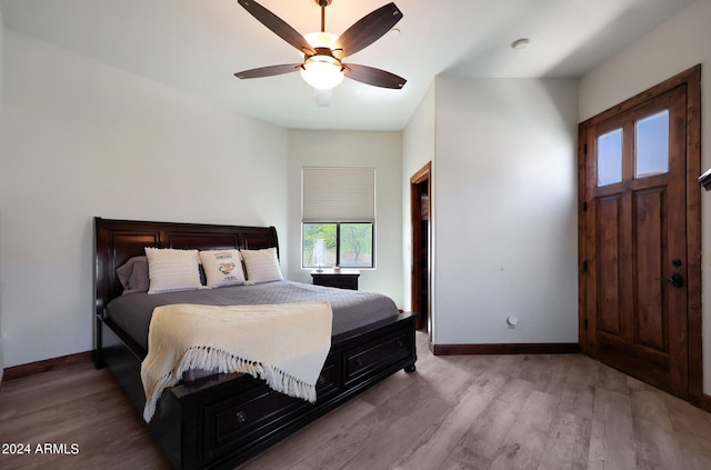 bedroom with light hardwood / wood-style flooring and ceiling fan