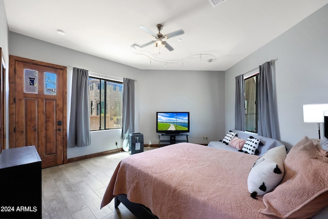 bedroom with ceiling fan and light hardwood / wood-style floors