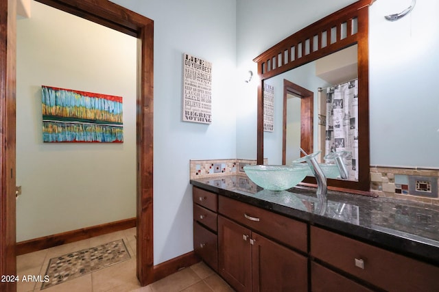 bathroom featuring vanity, decorative backsplash, and tile patterned flooring