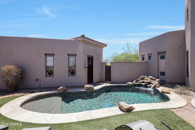 view of swimming pool with pool water feature