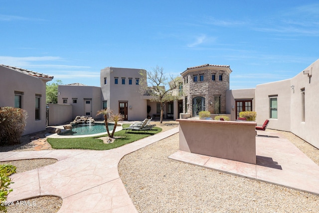 back of property with a patio