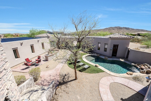 view of pool with a mountain view and a patio area