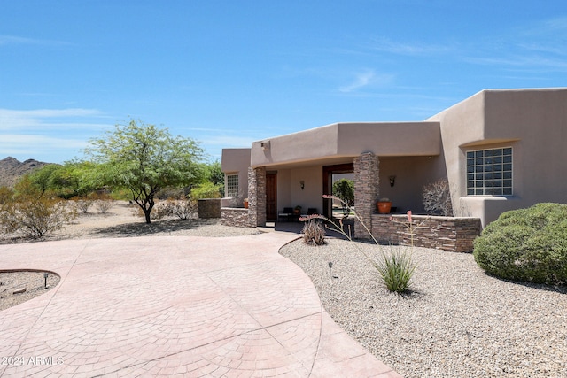 pueblo-style home featuring a patio area