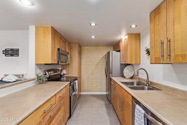 kitchen with light countertops, recessed lighting, appliances with stainless steel finishes, and a sink