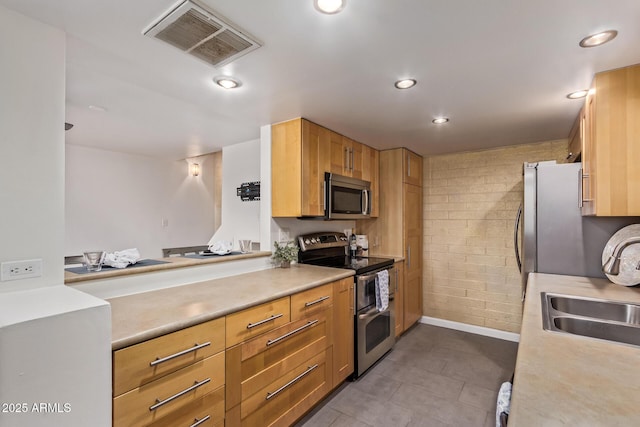 kitchen featuring visible vents, appliances with stainless steel finishes, and light countertops