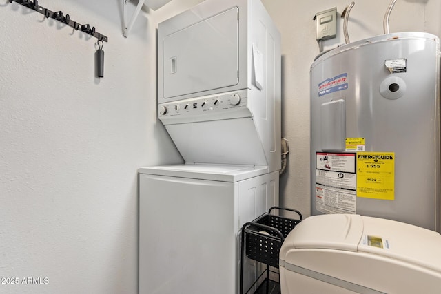 laundry room featuring stacked washer and dryer, electric water heater, and laundry area