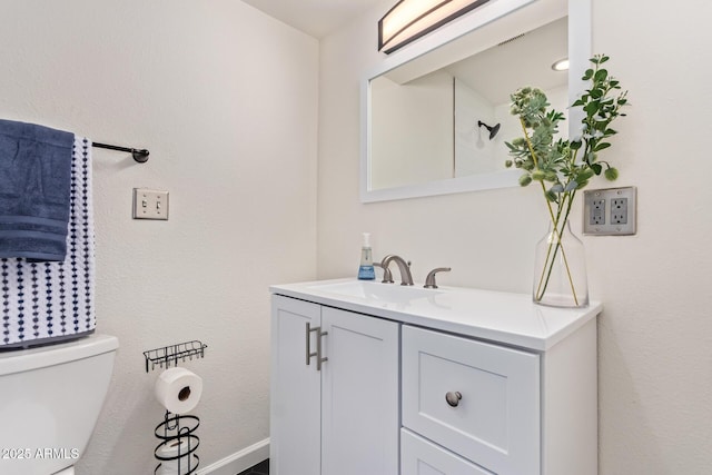 bathroom featuring vanity and toilet