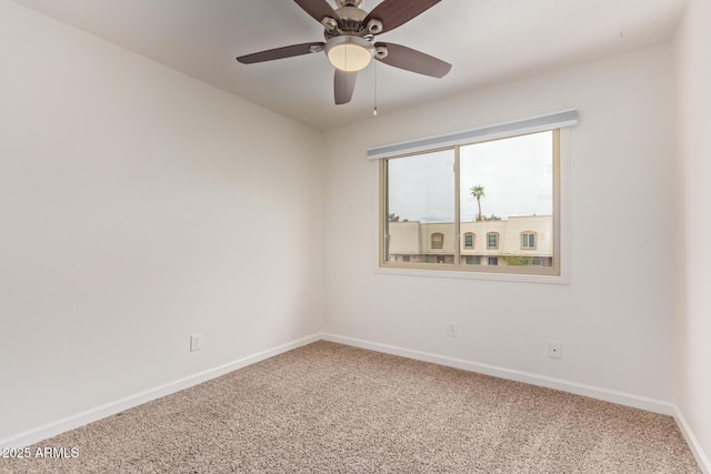 empty room with baseboards, ceiling fan, and carpet flooring