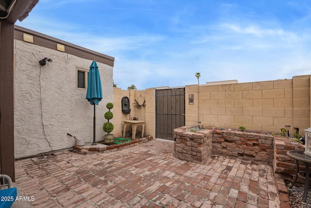 view of patio with a gate and fence