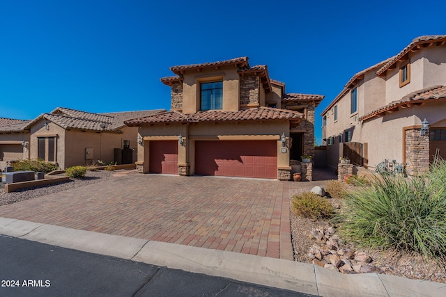 mediterranean / spanish home featuring a garage