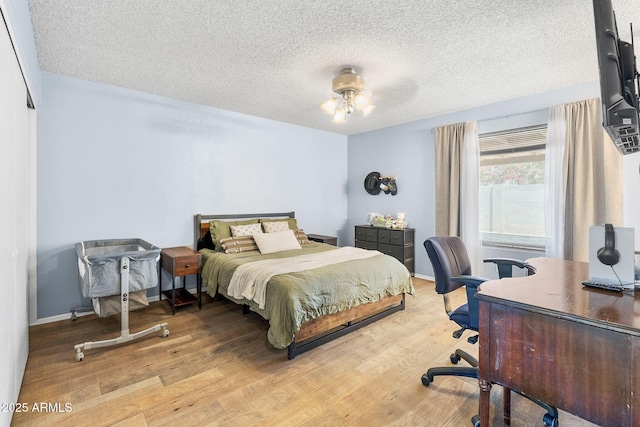 4631 N 77th Dr, Phoenix, AZ 85033 - bedroom featuring a ceiling fan, a textured ceiling, and wood finished floors