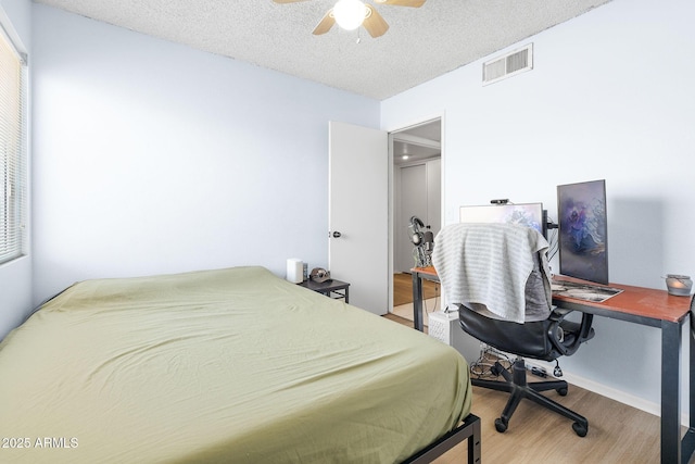 4631 N 77th Dr, Phoenix, AZ 85033 - bedroom with ceiling fan, a textured ceiling, visible vents, and wood finished floors