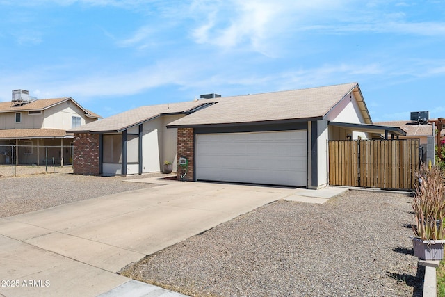 4631 N 77th Dr, Phoenix, AZ 85033 - view of front of house featuring a garage, fence, driveway, and brick siding