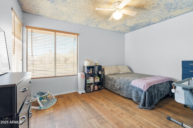 4631 N 77th Dr, Phoenix, AZ 85033 - bedroom with baseboards, ceiling fan, and wood finished floors