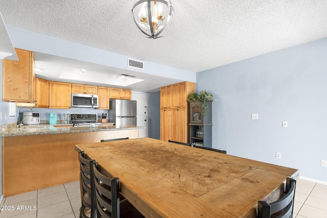 4631 N 77th Dr, Phoenix, AZ 85033 - dining space with visible vents, a textured ceiling, and light tile patterned floors