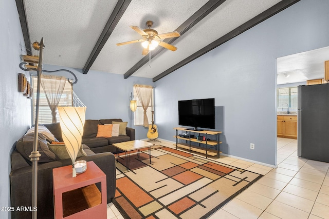 4631 N 77th Dr, Phoenix, AZ 85033 - living room with ceiling fan, a textured ceiling, light tile patterned floors, baseboards, and vaulted ceiling with beams