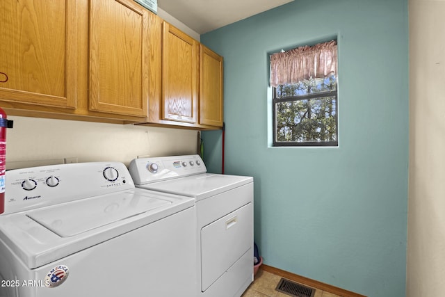 laundry area featuring cabinets and independent washer and dryer