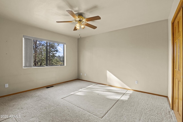 spare room featuring ceiling fan and carpet floors