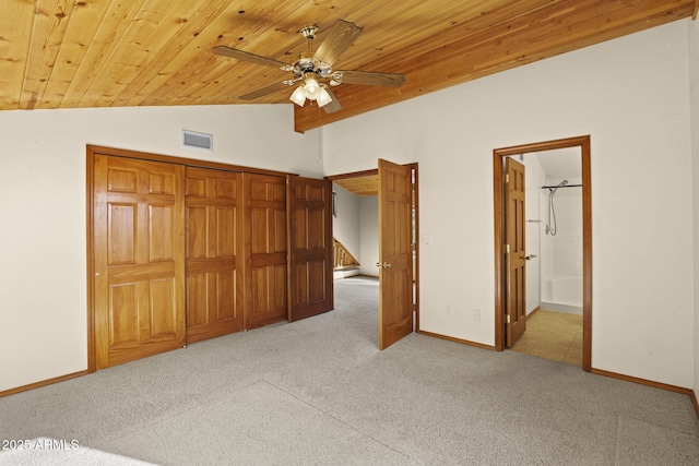 unfurnished bedroom with light carpet, wood ceiling, ceiling fan, ensuite bath, and vaulted ceiling