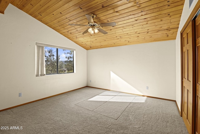 spare room featuring ceiling fan, vaulted ceiling, wood ceiling, and carpet flooring