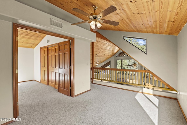 additional living space featuring ceiling fan, lofted ceiling, wood ceiling, and carpet flooring