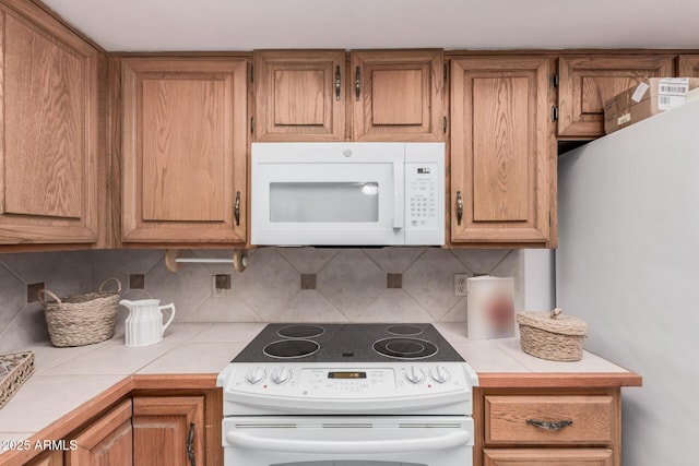 2956 E Concho Ave, Mesa, AZ 85204 - kitchen featuring white appliances, tasteful backsplash, tile counters, and brown cabinetry