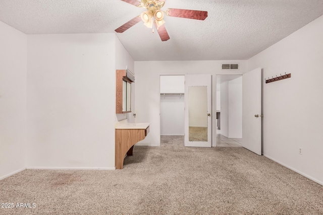 2956 E Concho Ave, Mesa, AZ 85204 - unfurnished bedroom with light colored carpet, a textured ceiling, ceiling fan, a walk in closet, and a closet