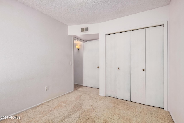 2956 E Concho Ave, Mesa, AZ 85204 - unfurnished bedroom featuring a textured ceiling, a closet, and carpet flooring