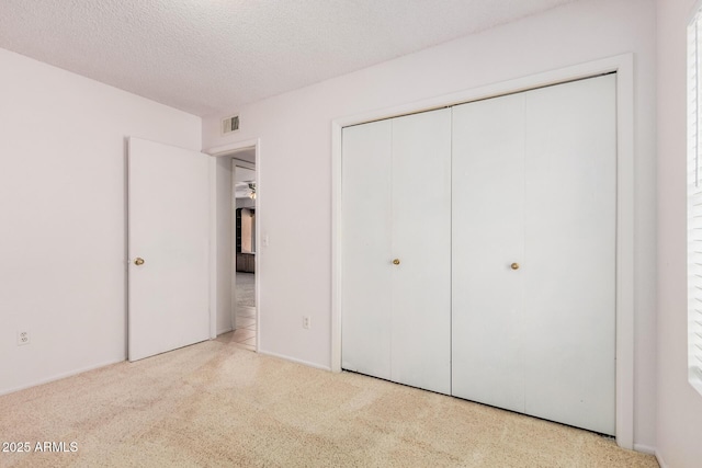 2956 E Concho Ave, Mesa, AZ 85204 - unfurnished bedroom featuring a textured ceiling, a closet, and carpet floors