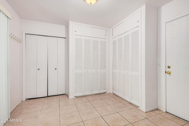 2956 E Concho Ave, Mesa, AZ 85204 - unfurnished bedroom with multiple closets and light tile patterned floors