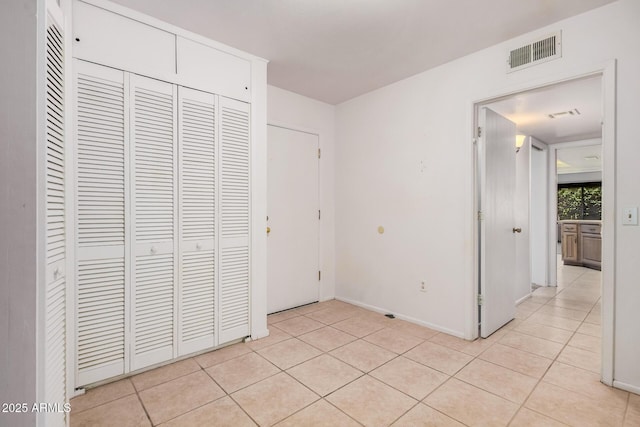 2956 E Concho Ave, Mesa, AZ 85204 - unfurnished bedroom featuring light tile patterned floors and a closet