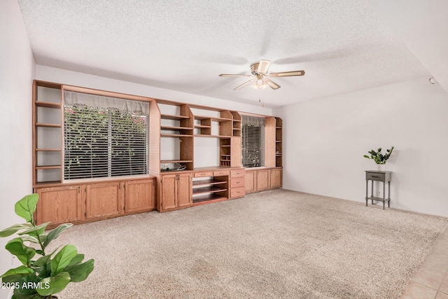 2956 E Concho Ave, Mesa, AZ 85204 - unfurnished living room featuring a ceiling fan, light colored carpet, and a textured ceiling