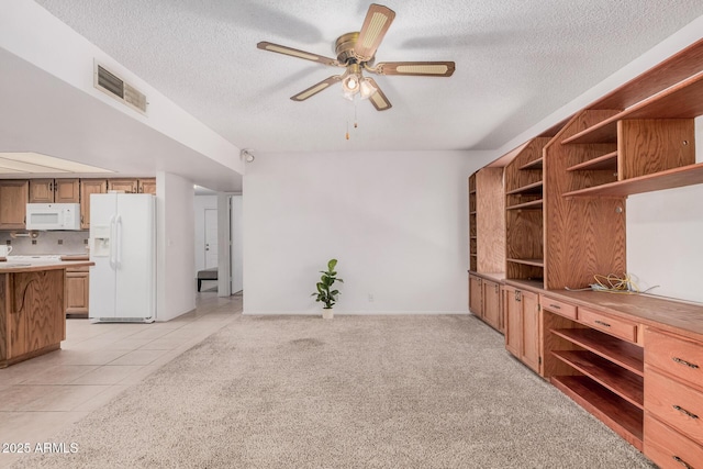 2956 E Concho Ave, Mesa, AZ 85204 - unfurnished living room with a textured ceiling, ceiling fan, light tile patterned floors, and light carpet