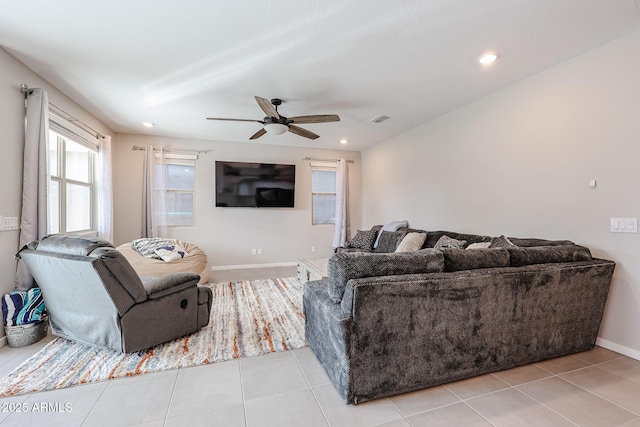 living area featuring light tile patterned floors, baseboards, visible vents, and recessed lighting