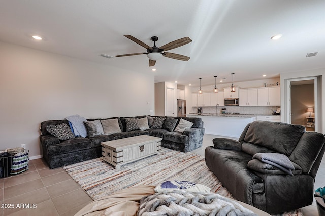 living room with light tile patterned floors, ceiling fan, visible vents, and recessed lighting