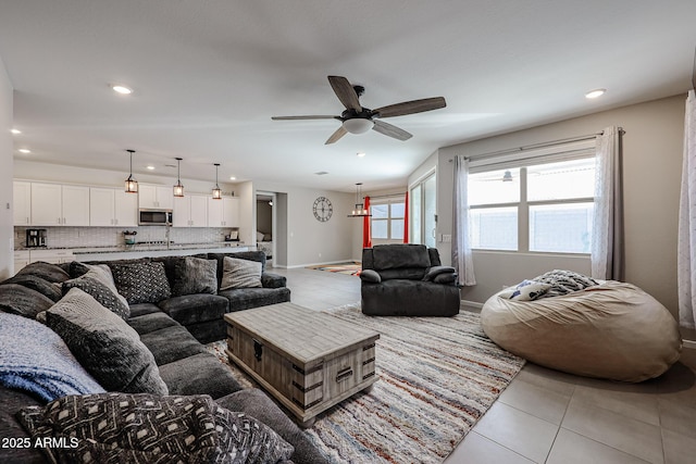 living room with light tile patterned floors, ceiling fan, baseboards, and recessed lighting