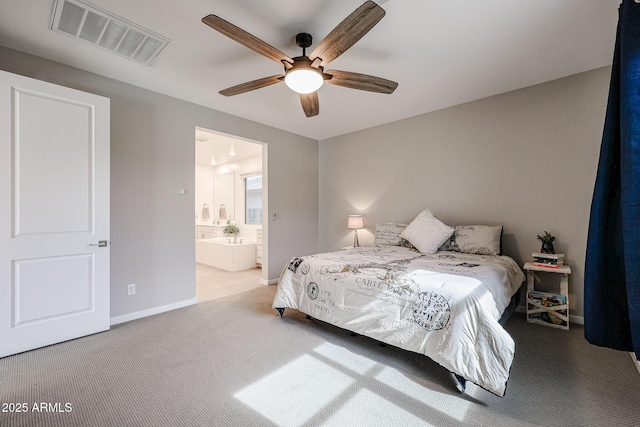 bedroom featuring baseboards, visible vents, a ceiling fan, light colored carpet, and ensuite bathroom