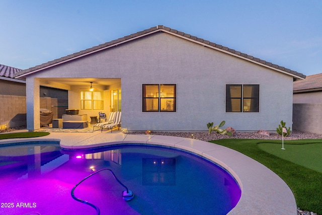 view of swimming pool with a ceiling fan, a fenced in pool, a patio area, and fence