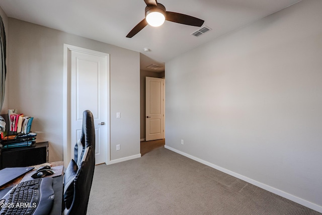 home office with baseboards, a ceiling fan, visible vents, and light colored carpet