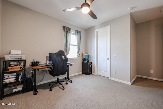 office area featuring baseboards, visible vents, a ceiling fan, and light colored carpet