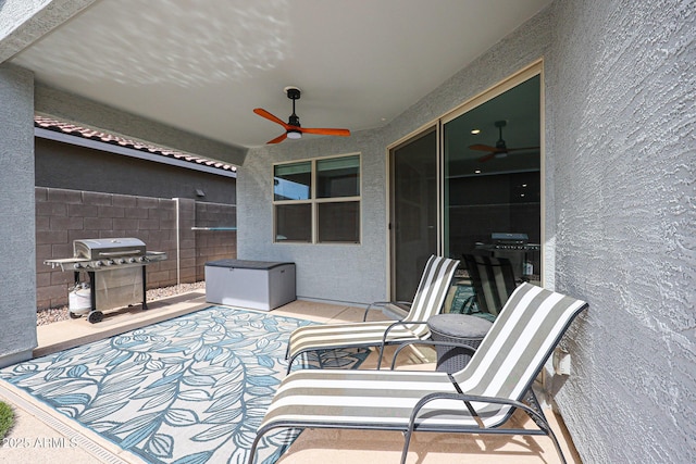 view of patio featuring ceiling fan, a grill, and fence