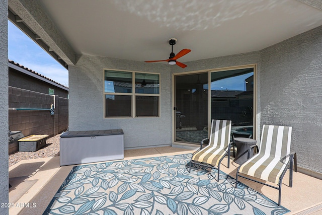 view of patio / terrace featuring ceiling fan and fence